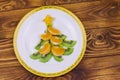 Christmas tree made of kiwi slices and mandarin lobules on wooden table. Top view Royalty Free Stock Photo