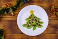 Christmas tree made of kiwi slices and pomegranate and Christmas decor on wooden table. Top view Royalty Free Stock Photo