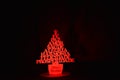 Christmas tree made of MDF wood with red light. Studio\'s photo. Black background Royalty Free Stock Photo