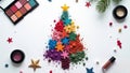 Christmas tree made of multi-colored shadows on a white background with eyeshadow palettes, top view Royalty Free Stock Photo