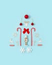 Christmas tree made with nutcracker snowflake, ribbon, dear horns and candies on bright pastel blue background. Flat lay. Copy Royalty Free Stock Photo