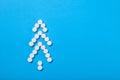 Christmas tree of pills on a blue. Royalty Free Stock Photo