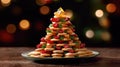 Christmas tree made of layered cheese and vegetables with a star on top.