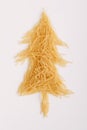 Christmas tree made of raw chopped noodles isolated on white background