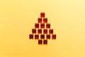 Christmas tree made of red gifts on a golden background