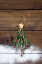 Christmas tree made of rosemary and pomegranate with star-shaped cookie Royalty Free Stock Photo