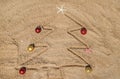 Christmas tree made of shells in the sand. Selective focus Royalty Free Stock Photo