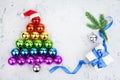 Christmas tree made of shiny decorations balls LGBT community rainbow flag colors, Santa Claus hat, gift box, blue ribbon, pine Royalty Free Stock Photo