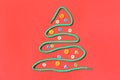 Christmas tree made of shoe lace and different buttons on red background, flat lay Royalty Free Stock Photo