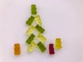 Christmas tree made of white and green gummy bears. next to a Christmas tree bright bears made of gelatin. delicious and juicy