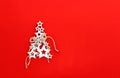 Christmas tree made of white wooden stars with snowflake and craft twine on bright red background with copy space. Royalty Free Stock Photo