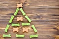 christmas tree maden from canine chewing bones and cookies on wooden background