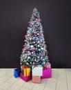 Christmas tree many present boxes dark background Royalty Free Stock Photo