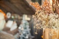 Christmas tree near the bed. Dried grass in a vase, defocus, bokeh. Scandinavian style bedroom interior under Christmas. Rustic Te Royalty Free Stock Photo