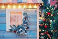 Christmas tree near vintage wooden house, waiting for the new year celebration Royalty Free Stock Photo