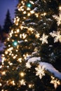 Christmas tree with new year holiday decoration in a city street at night, houses with lights, winter, snow Royalty Free Stock Photo
