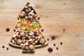 Christmas tree with nuts and dried fruits on wooden background Royalty Free Stock Photo