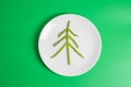 Christmas tree of organic Asparagus with fork and knife on green background. Merry Xmas and happy New Year party, New You, Healthy Royalty Free Stock Photo