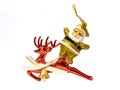 Christmas tree ornament of the golden Santa Claus glued on the reindeer on white background Royalty Free Stock Photo