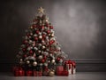 A christmas tree with ornaments and presents in front of a grey wall. Copy space, place for text