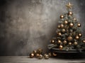A christmas tree with ornaments and presents in front of a grey wall. Copy space, place for text