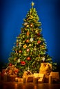 Christmas Tree over Blue Background, New Year Decorations Hanging on Chritmastree, Present Gifts and Bag