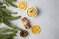 Christmas Tree Pine Brancheswith present, orange, cake, cinnamon on grey background. Royalty Free Stock Photo