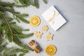 Christmas Tree Pine Brancheswith present, orange, cake, cinnamon on grey background. Royalty Free Stock Photo