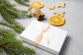 Christmas Tree Pine Brancheswith present, orange, cake, cinnamon on grey background. Royalty Free Stock Photo