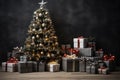 Christmas tree with presents in front of a black wall with copy space . Royalty Free Stock Photo