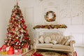 Christmas tree with presents underneath in living room Royalty Free Stock Photo