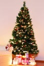 Christmas tree with presents underneath in living room Royalty Free Stock Photo