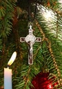 Christ cross lit candle ornament on Christmas tree Royalty Free Stock Photo