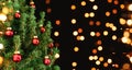 Christmas tree with red Christmas decorations on dark holiday background with bokeh, blurred, sparking Royalty Free Stock Photo