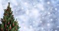 Christmas tree with red Christmas decorations on holiday background with snow, blurred, sparking, glowing. Royalty Free Stock Photo