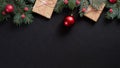 Christmas tree with red decorations and gifts on black background. Flat lay, top view, overhead. Christmas banner mockup Royalty Free Stock Photo