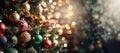 Christmas tree with red gold ornaments and baubles on bright blurred bokeh lights background banner
