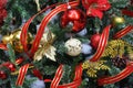 Christmas tree with red, gold and white ornaments and red ribbon garlands Royalty Free Stock Photo