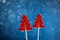 Christmas tree red sweet candies, snow bokeh blue background