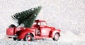 Christmas tree on red toy car trunk Royalty Free Stock Photo