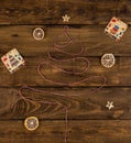 Christmas tree from red and white rope on wooden background with gift cards, dry citruses and golden stars decoration Royalty Free Stock Photo