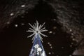 Christmas tree reflecting in water.