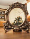 Christmas tree reflection in a old style bronze mirror. Abstract background, Selective focus. Dining room in the background Royalty Free Stock Photo