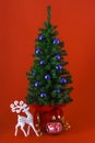 Christmas tree with reindeer and ornament on red background Royalty Free Stock Photo