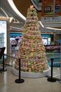 Chinese Christmas tree made from many colorful stuffed toys in shape of small cute mouse. Lunar New Year decorations in shop