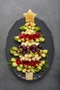 Christmas tree shape appetizers board: cheese, olives, brussels sprout, beef cold cut