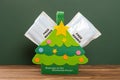 a Christmas tree shape bag with free masks concept of healthy holidays