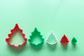 Christmas tree shape gingerbread cookie cutters on green background, top view Royalty Free Stock Photo