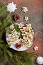 Christmas tree shape gingerbread cookies covered with white and dark chocolate, decorated with chopped pistachio nuts Royalty Free Stock Photo