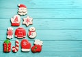 Christmas tree shape made of delicious gingerbread cookies on light blue wooden table, flat lay. Space for text Royalty Free Stock Photo